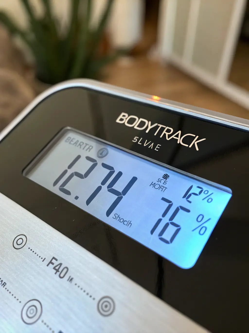 A high-quality image of a digital smart scale displaying body composition metrics like weight, body fat percentage, and muscle mass, set against a clean, modern bathroom background.